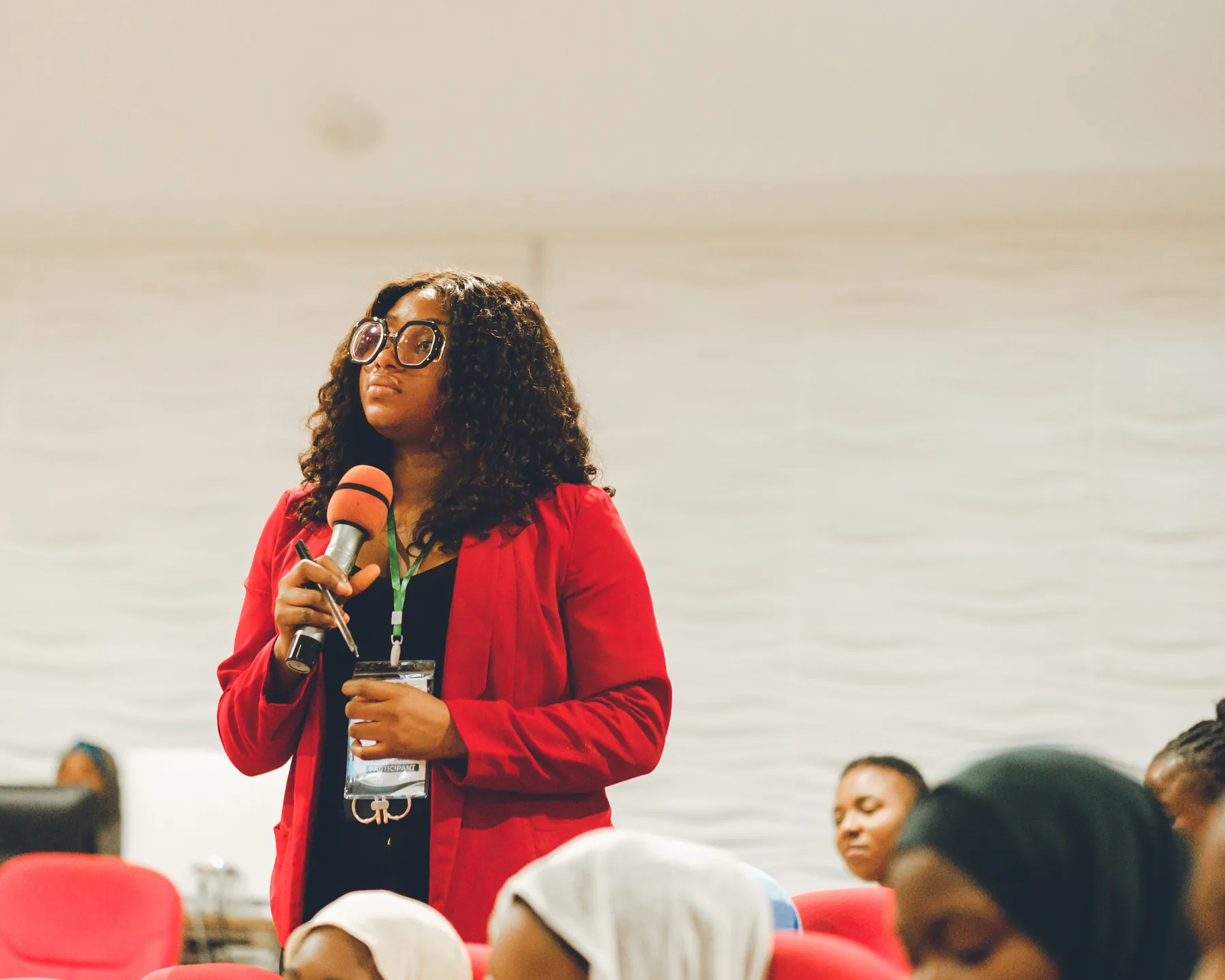 A conference participant speaking into a microphone